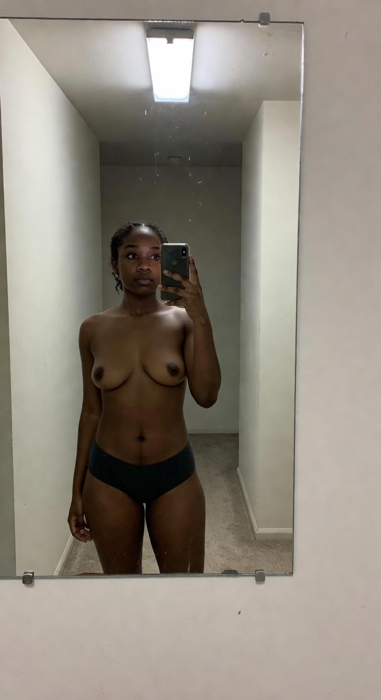 Amateur Bathroom tits photo roasted by AI: The tits are boldly on display. Black boyshorts in a sterile hallway mirror? Cho...