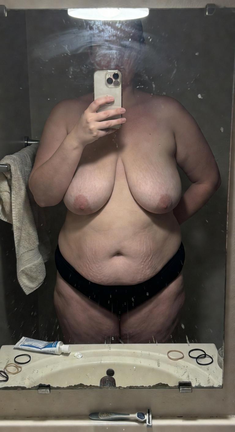 Amateur Bathroom tits photo roasted by AI: Steamy bathroom mirror selfie with those hanging free. Toothbrush, toothpaste tu...