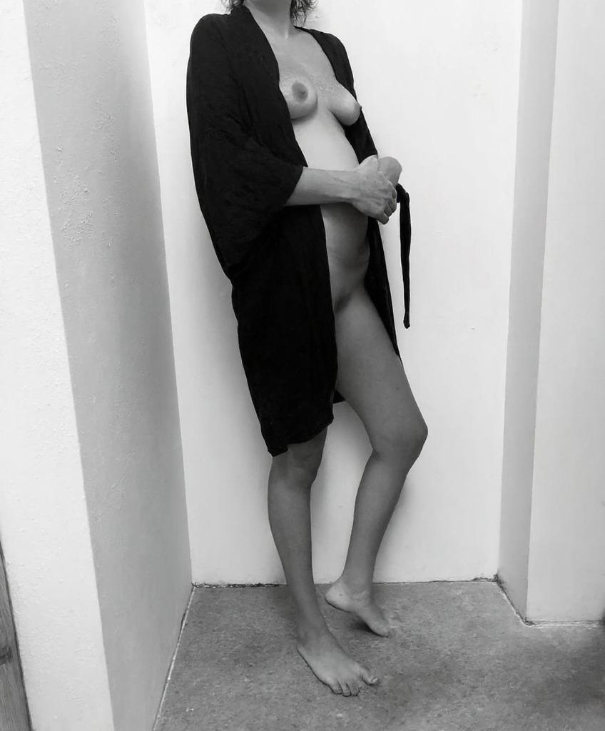 AI-roasted photo: the robe is hanging on like a plot twist nobody asked for and the concrete floor is the real star here